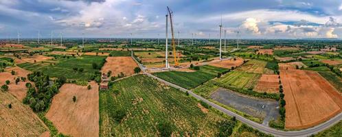 Panoramic view of wind farm or wind park, in the meadow field  are one of the cleanest, renewable electric energy source. with high wind turbines for generation electricity. Green energy concept. photo