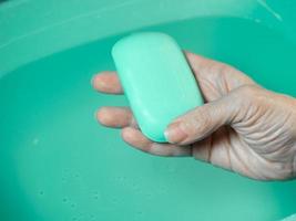 Hand washing. Toilet soap in hand. Green soap. Hand washing. photo