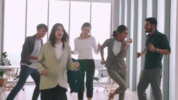 Business people celebrating by dancing at a meeting in office. video