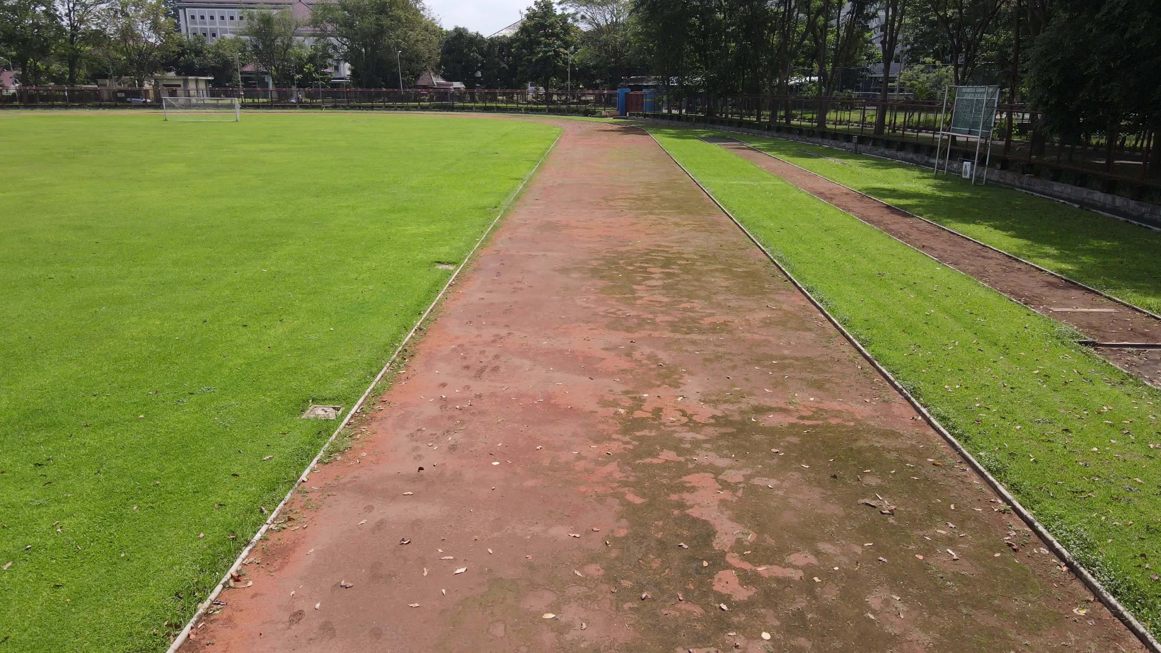 Aerial drone shot of a running track in around soccer field 9160141