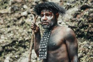 primer plano papua hombre de la tribu dani contra el fondo de la naturaleza. foto