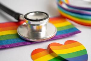 Black stethoscope with rainbow flag heart on white background, symbol of LGBT pride month  celebrate annual in June social, symbol of gay, lesbian, bisexual, transgender, human rights and peace. photo