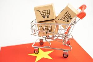 Box with shopping online cart logo and Vietnam flag, Import Export Shopping online or commerce finance delivery service store product shipping, trade, supplier concept. photo