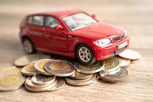 Bangkok, Thailand - January 20, 2022 Car on stack of coins. Car loan, Finance, saving money, insurance and leasing time concepts. photo