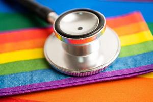 Black stethoscope with rainbow flag heart on white background, symbol of LGBT pride month  celebrate annual in June social, symbol of gay, lesbian, bisexual, transgender, human rights and peace. photo