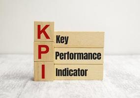 wooden cube block with KPI KEY, Performance and Indicator word on table background. Business concept photo