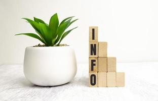 four wooden blocks with the letters info on the bright surface of a gray table photo