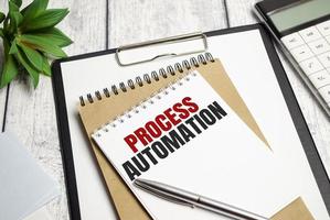 Text PROCESS AUTOMATION on Office desk on wooden background photo