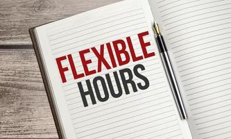 FLEXIBLE HOURS text on notepad with pen, business concept photo