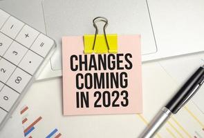 change is coming text write on paper and calculator on wooden background photo