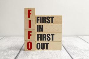 FIFO First in, first out word on wooden cubes on wooden background photo