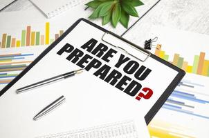 Are You Prepared. text on notepad on wood table photo