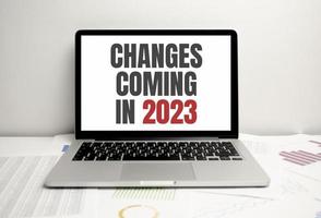 change is coming text write on paper and calculator on wooden background photo