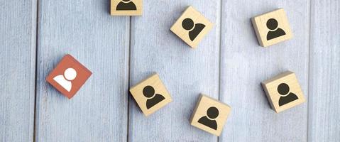 wooden cube blocks with printed blue human symbol. Leadership and team building concept photo