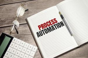 PROCESS AUTOMATION text on brown diary on wooden background photo