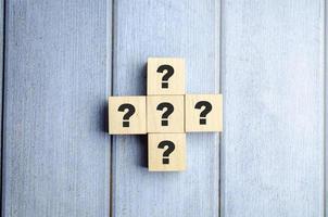 Close-Up Of Toy Blocks Question Marks On Table photo