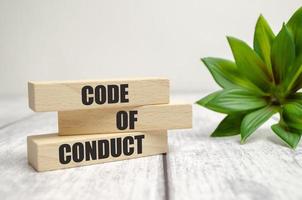 Code of conduct symbol. Concept words Code of conduct on wooden blocks on white background photo