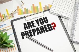 Are You Prepared. text on notepad on wood table photo