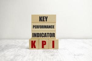 wooden cube block with KPI KEY, Performance and Indicator word on table background. Business concept photo