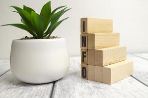 four wooden blocks with the letters info on the bright surface of a gray table photo