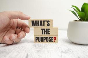 WHAT IS THE PURPOSE text on wooden block photo