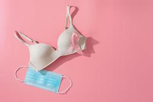 Bra with breast cancer awareness ribbon and hygienic mask. breast cancer coronavirus, Cancer awareness concept photo