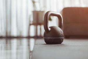 Gym equipment, kettlebell dumbbell weight on yoga mat at home. Home exercise.