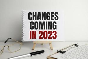 change is coming text write on paper and calculator on wooden background photo