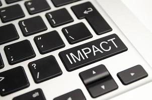 Impact button on keyboard - business concept photo