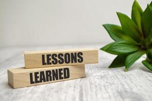 The word Lessons Learned was created from wooden cubes photo