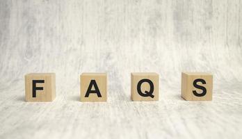 FAQS Frequently asked questions text written on wooden block photo