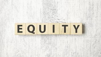 equity word background on wood blocks and white background photo