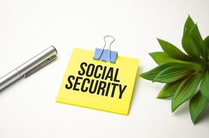 The text Social Security on yellow sticker and white background photo