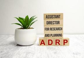 adrp word on wooden block and white background photo