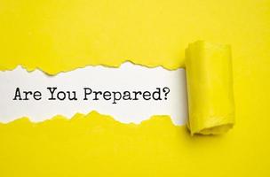 The text Are You Prepared Question appearing behind torn yellow paper photo