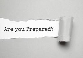 The text Are You Prepared Question appearing behind torn grey paper photo