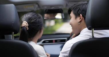 Portrait of Asian couple waving hand and looking at camera. Man and woman smiling. Travel and lifestyle concept. video