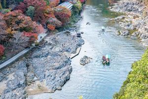 colorful leaves mountains and Katsura river in Arashiyama, landscape landmark and popular for tourists attractions in Kyoto, Japan. Fall Autumn season, Vacation,holiday and Sightseeing concept photo
