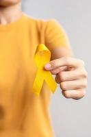 Suicide prevention day, Childhood, Sarcoma, bone and bladder cancer Awareness month, Yellow Ribbon for supporting people life and illness. Healthcare photo