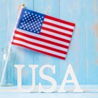 USA text and United States of America flag on wooden table background. concept of Veterans, Memorial, Independence and Labor Day photo