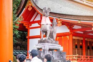 Fox sculpture in Fushimi Inari-taisha shrine in fall autumn season, located in Fushimi-ku. landmark and popular for tourists attractions in Kyoto. Kyoto, Japan, 27 November 2019 photo