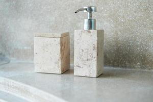 Toiletries bottles in bathroom at luxury hotel or modern home. body shower gel in ceramic ware with wall background photo