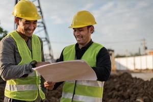 Engineers working on building site. Construction manager and engineer meeting and discussion about project in construction site. photo