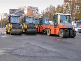 Ukraine, Kharkiv, October 27, 2020. Close-up view on the workers and the asphalting machines. Roller and workers on asphalting and repair of city streets. High quality photo