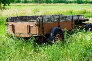 an abandoned and forgotten old agricultural utility vehicle in the old country of Hamburg photo