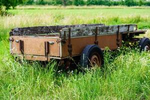 an abandoned and forgotten old agricultural utility vehicle in the old country of Hamburg photo