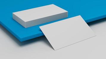 White business card Mockup laying on blue background. Visiting card laying on colored surface photo