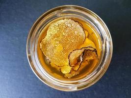fresh bee honey from the beekeeper with finely shaved truffle slices photo
