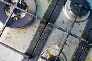 Dirty gas stove with food leftovers and crumbs photo