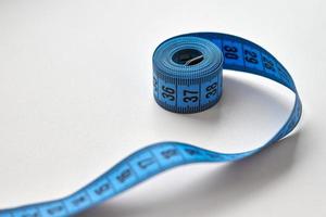 Blue measuring tape isolated on white background photo